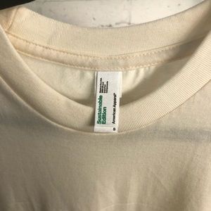 T-shirt. Color is off white or cream colored